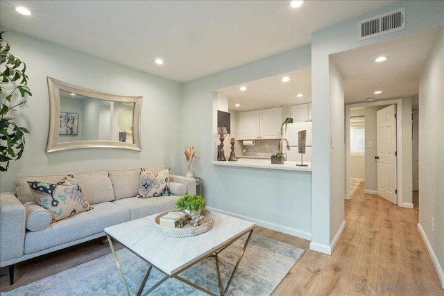 living room with light hardwood / wood-style floors