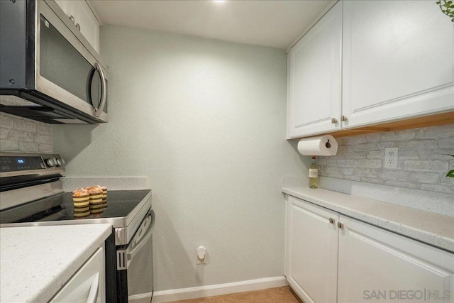 kitchen featuring white cabinetry, tasteful backsplash, and appliances with stainless steel finishes