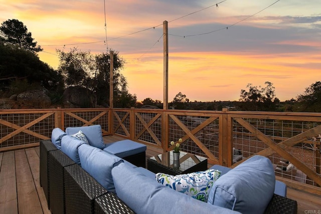 deck at dusk with an outdoor living space