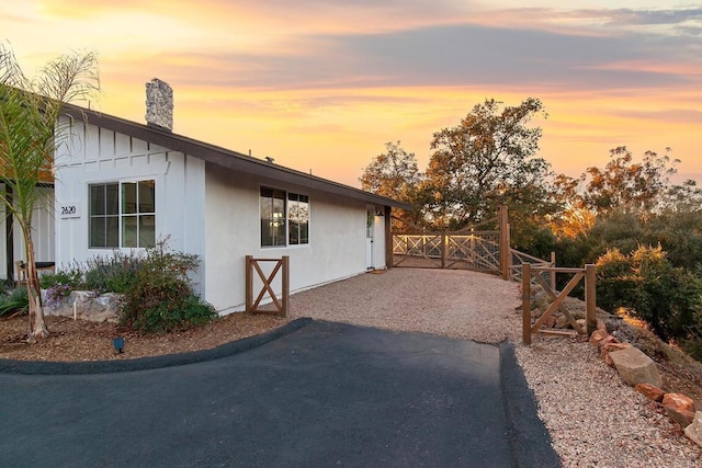 property exterior at dusk featuring a patio