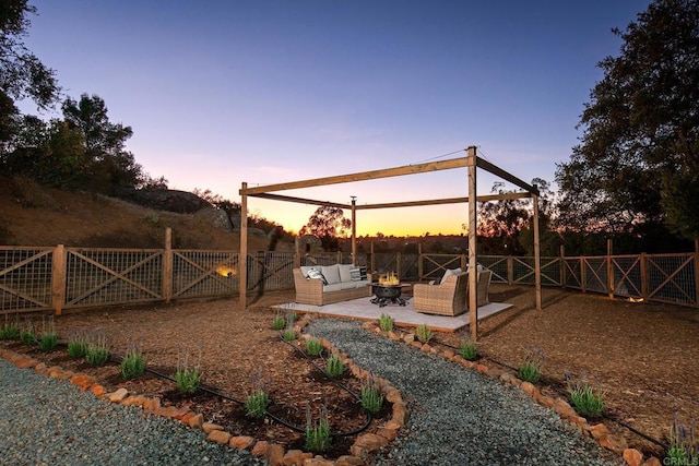 yard at dusk with a patio area and an outdoor hangout area