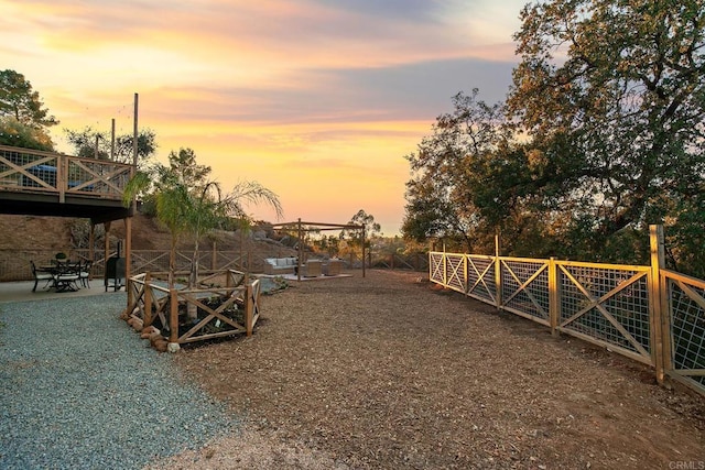 yard at dusk with a patio area