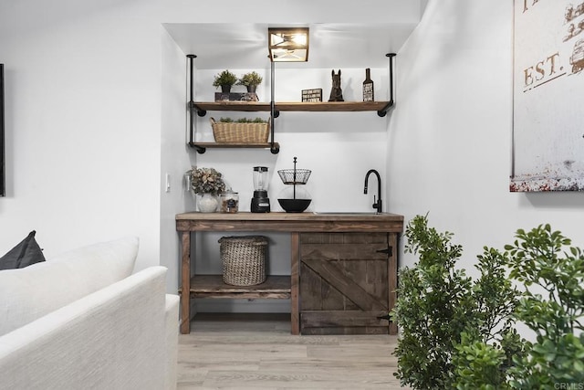 bar featuring light hardwood / wood-style floors