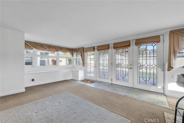 unfurnished sunroom featuring a healthy amount of sunlight and french doors