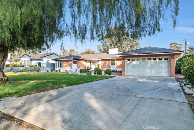 single story home with a garage, a chimney, concrete driveway, and a front lawn