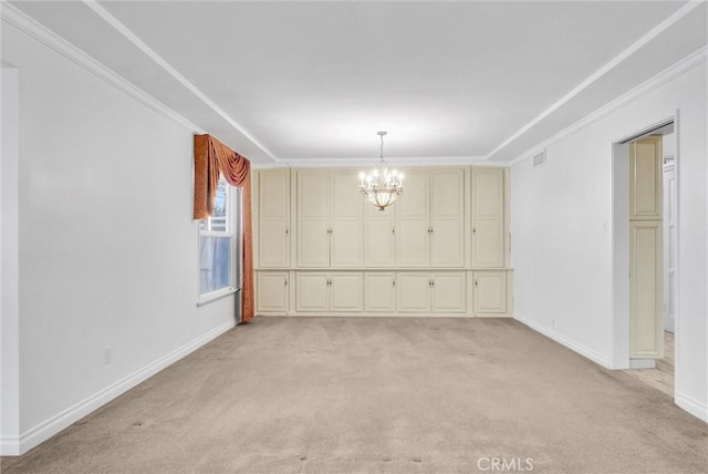 spare room with light carpet, a notable chandelier, and ornamental molding