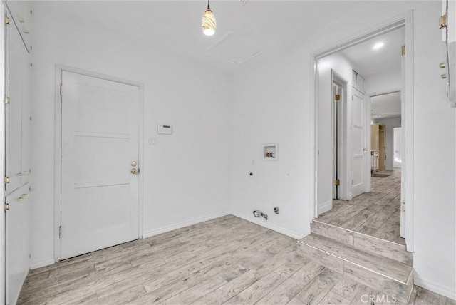 washroom featuring hookup for a gas dryer, washer hookup, and light hardwood / wood-style flooring