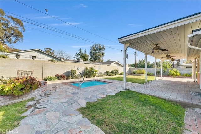 view of pool featuring a patio, ceiling fan, and a lawn