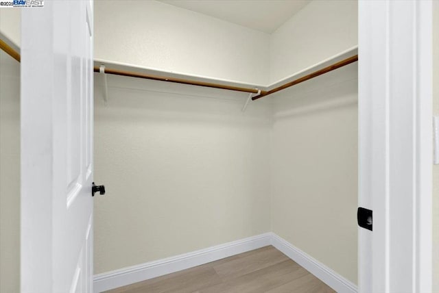 spacious closet featuring hardwood / wood-style floors