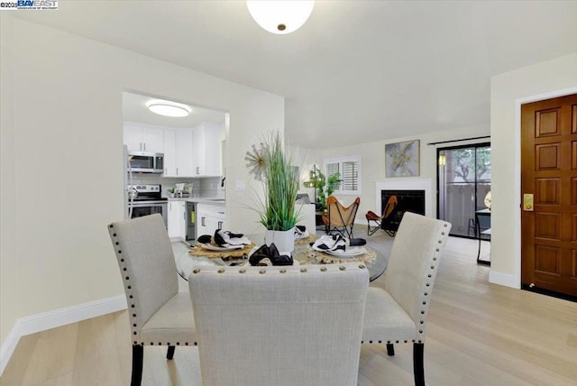 dining space featuring light hardwood / wood-style flooring and sink