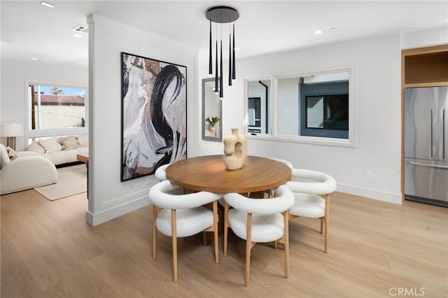 dining space featuring light wood-type flooring