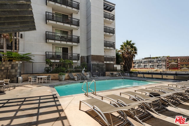 view of swimming pool with a patio area