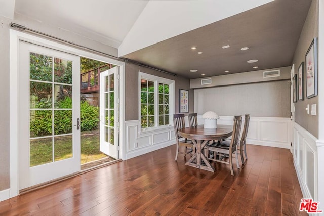 dining room featuring dark hardwood / wood-style flooring and vaulted ceiling