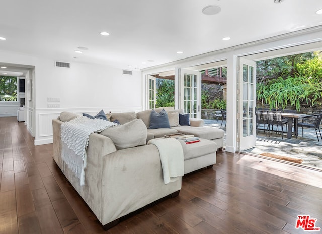 living room with dark wood-type flooring and a wealth of natural light