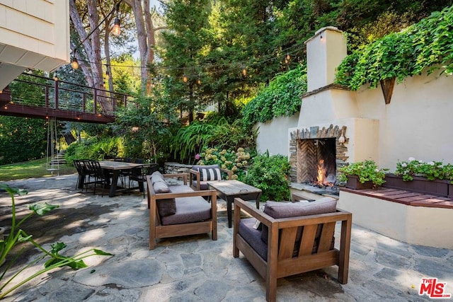 view of patio with an outdoor stone fireplace