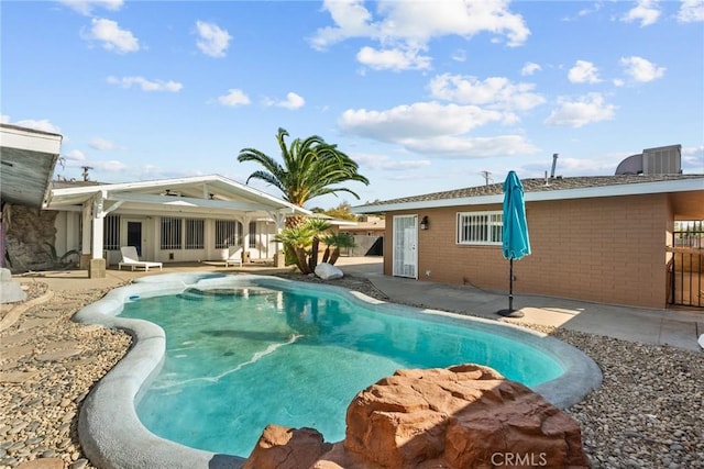 view of swimming pool with a patio area and central air condition unit