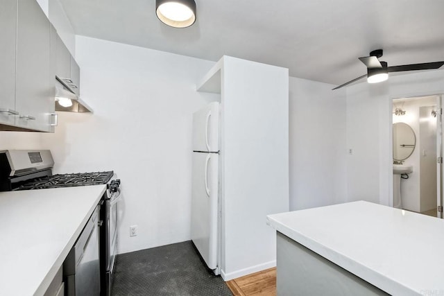 kitchen featuring ceiling fan, appliances with stainless steel finishes, and gray cabinetry