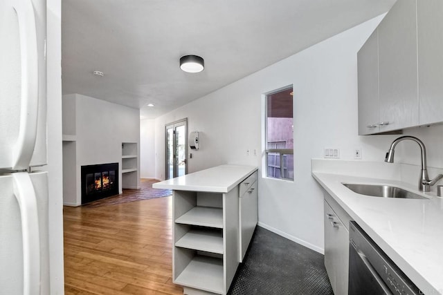 kitchen featuring dishwasher, refrigerator, kitchen peninsula, sink, and gray cabinetry