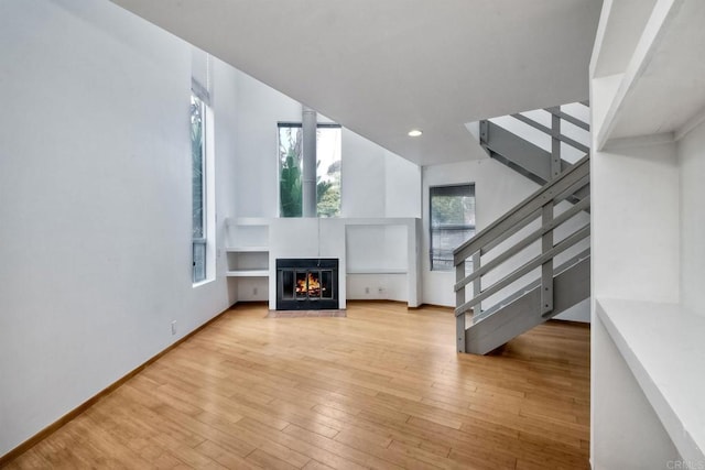 unfurnished living room with light hardwood / wood-style flooring