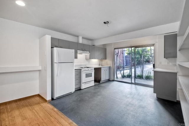 kitchen featuring white appliances and gray cabinetry