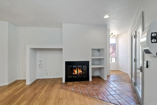 unfurnished living room with light wood-type flooring