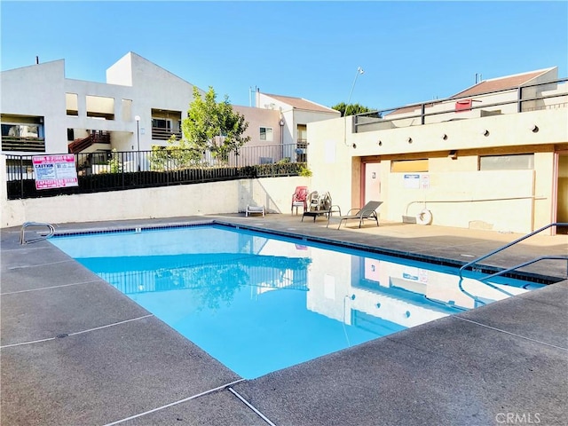 view of swimming pool featuring a patio area