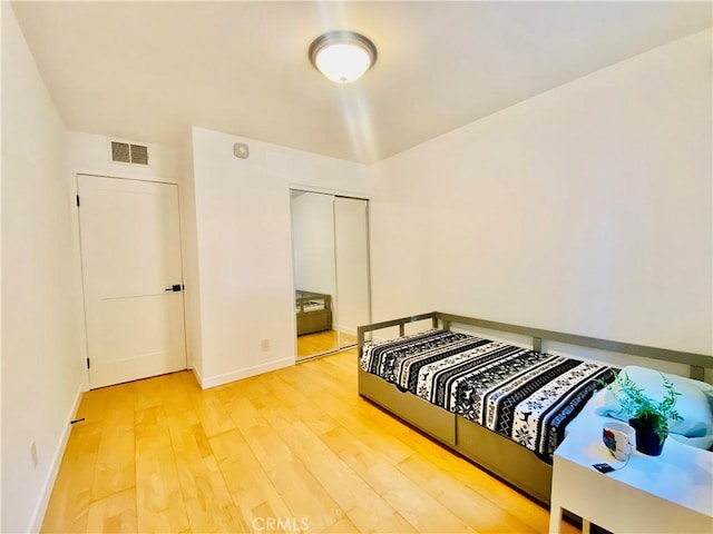 bedroom featuring a closet and light hardwood / wood-style flooring