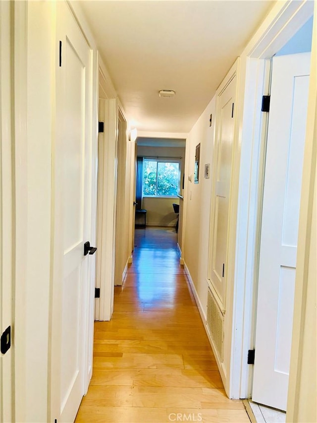 hallway with light hardwood / wood-style flooring