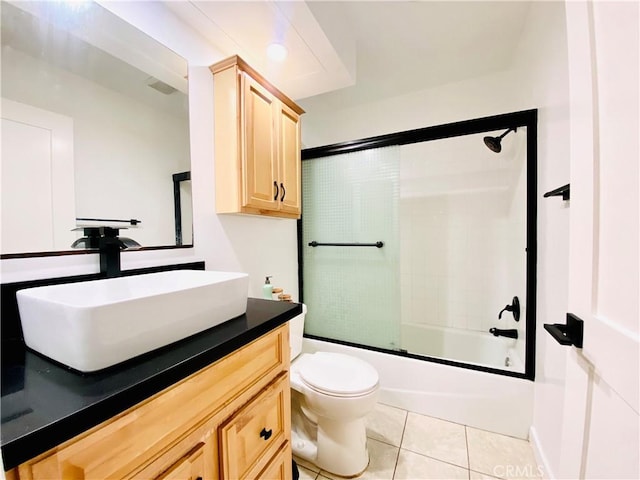 full bathroom with toilet, tile patterned flooring, vanity, and shower / bath combination with glass door