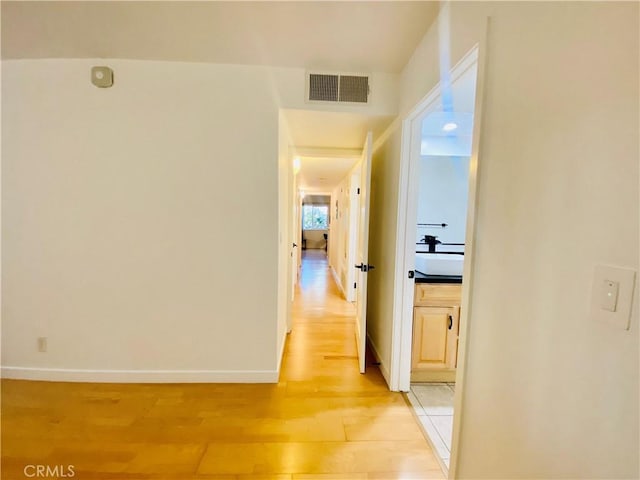 corridor featuring light wood-type flooring