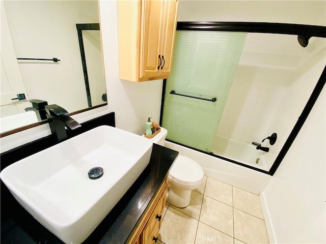 full bathroom featuring toilet, tile patterned flooring, enclosed tub / shower combo, and vanity