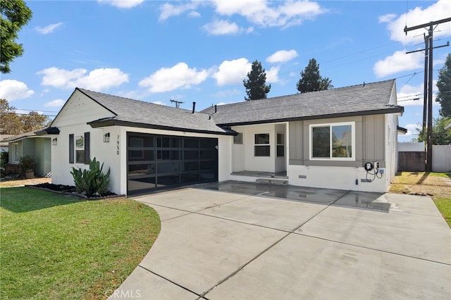 ranch-style house with a front yard and a garage