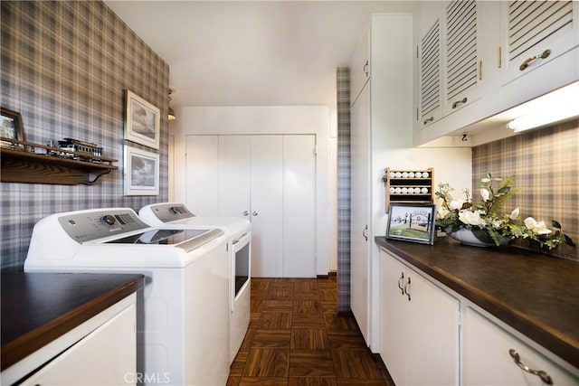 laundry room featuring dark parquet floors, separate washer and dryer, and cabinets