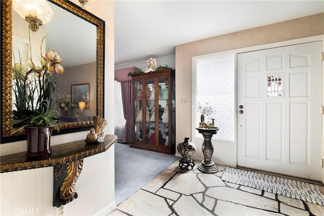 foyer with light colored carpet