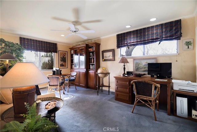 office space featuring ceiling fan, crown molding, and dark colored carpet