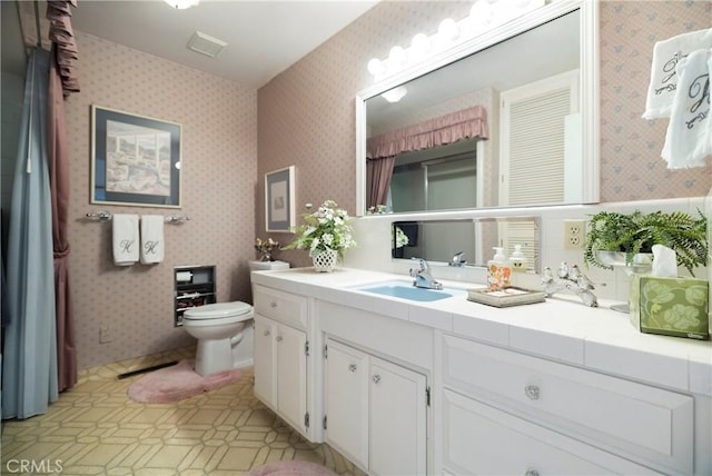 bathroom featuring toilet and vanity