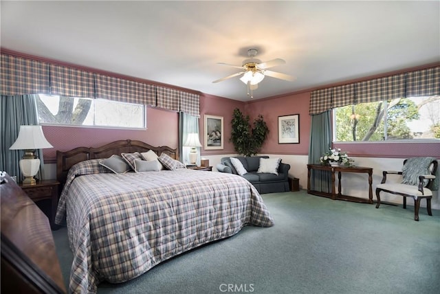 carpeted bedroom with ceiling fan and ornamental molding