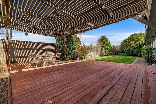 wooden terrace with a lawn and a pergola