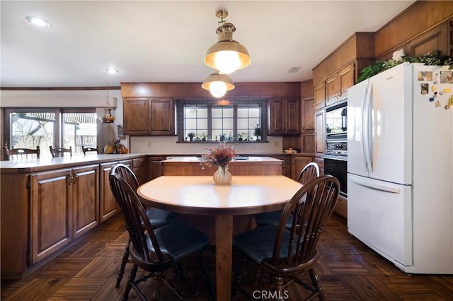 kitchen with black appliances, decorative light fixtures, and dark parquet flooring