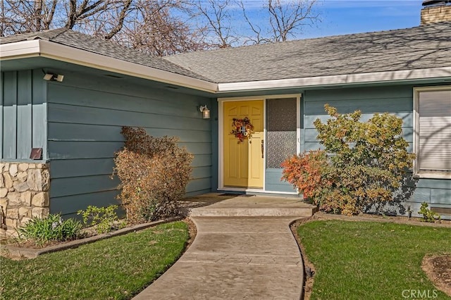 doorway to property with a yard