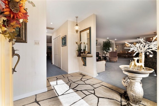 entryway featuring light colored carpet