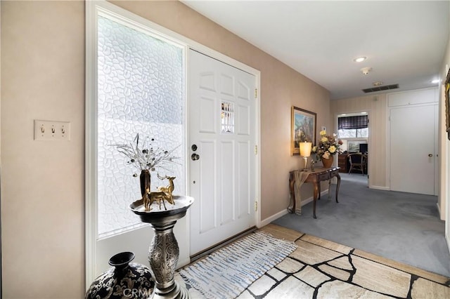 entrance foyer featuring light colored carpet