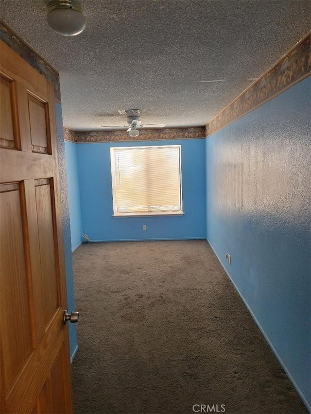 1217 Lill Hill Dr, Needles, CA 92363 - carpeted empty room with a textured ceiling
