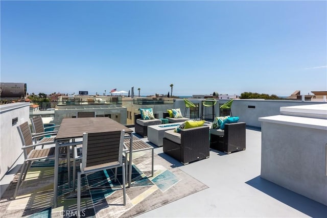 view of patio with an outdoor living space with a fire pit