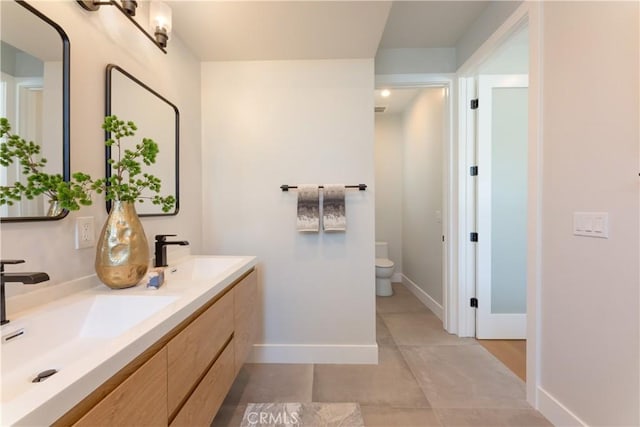 bathroom featuring toilet and vanity