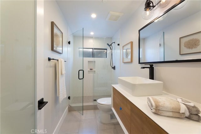 bathroom featuring toilet, vanity, an enclosed shower, and tile patterned flooring