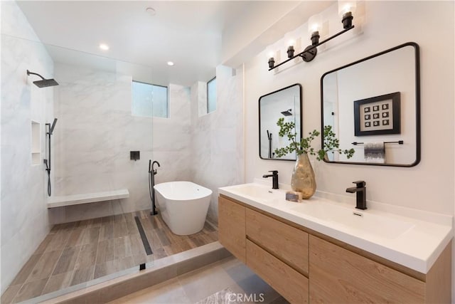 bathroom featuring vanity and shower with separate bathtub