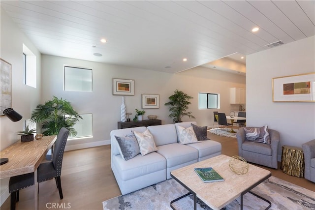 living room with wood ceiling and light hardwood / wood-style flooring