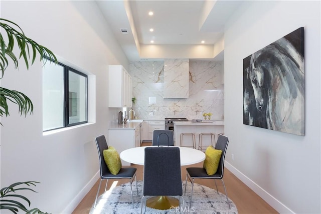 dining space featuring light wood-type flooring and sink