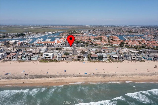 birds eye view of property with a view of the beach and a water view